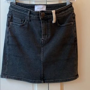 Black denim skirt with white pocket detail